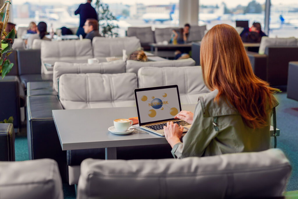 Woman connecting to airport wifi in an airport lounge