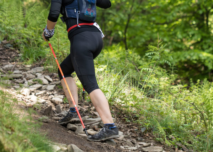 Woman hiking in woods wearing leggings