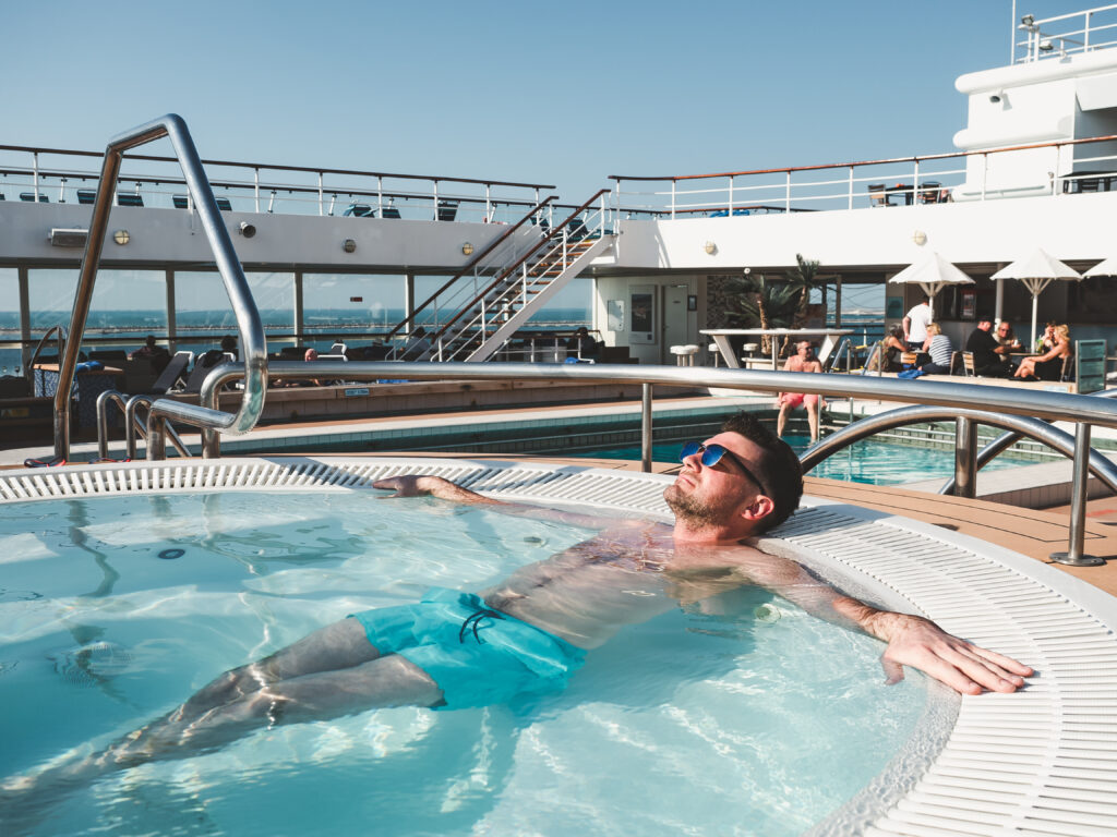 Man relaxing alone in a hot tub on a cruise ship deck