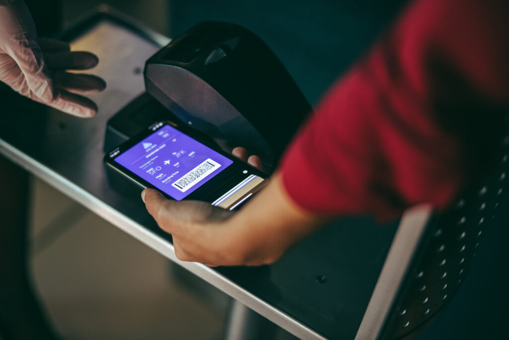 Close up of person scanning a digital boarding pass on a smartphone while boarding plane