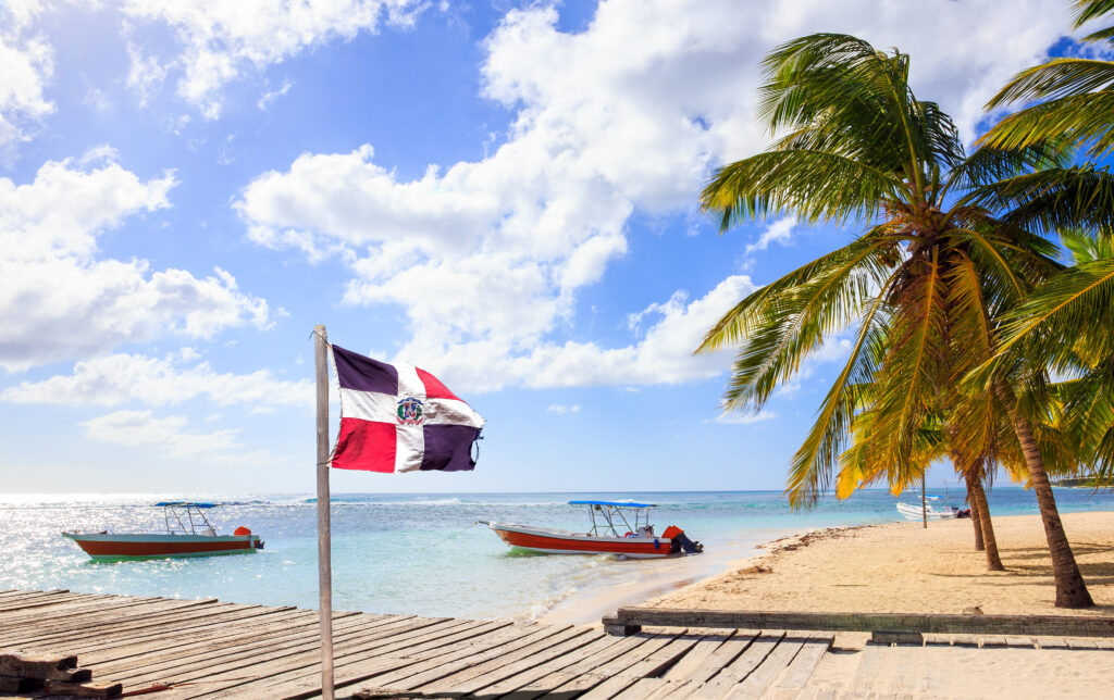 Beach in the Dominican Republic with the Domincan Republic flag in the foreground