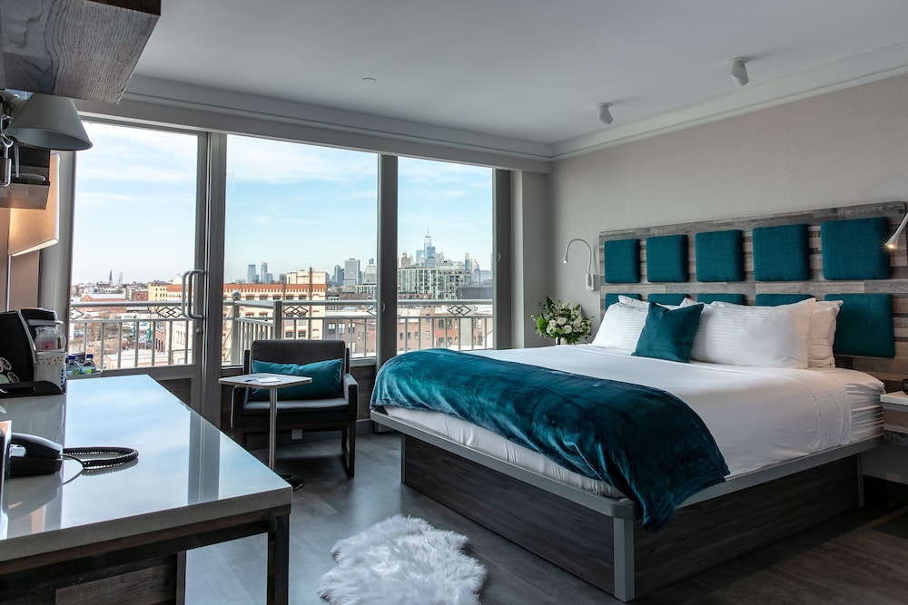 Bedroom overlooking the city skyline at Hotel Le Bleu in New York City