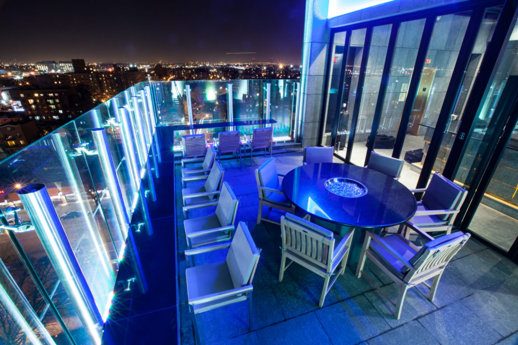 Balcony dining area lit up with blue lights at The One Boutique Hotel in New York City