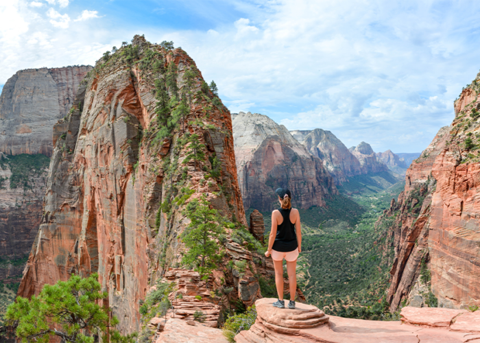 Woman standing on ledge in Zion National Park